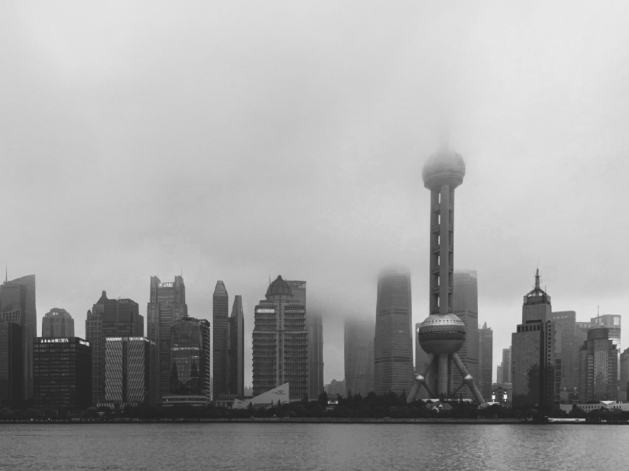 The Pudong skyline and Oriental Pearl Tower disappearing into fog