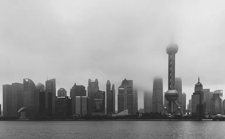 A black-and-white view of Pudong disappearing into fog