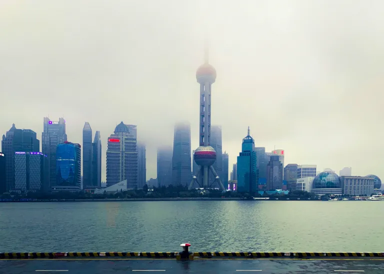 The Pudong skyline emerging through pale fog