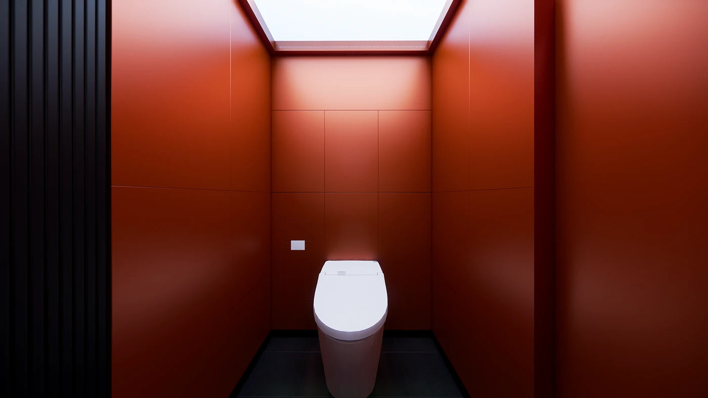 Toilet alcove framed by red wall panels and an artificial skylight